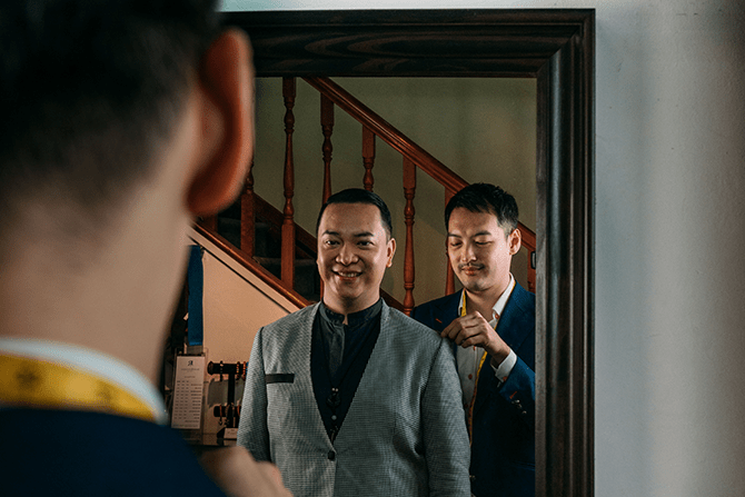 Chong Han San, founder of Q Menswear, taking measurements of The Clan Hotel staff