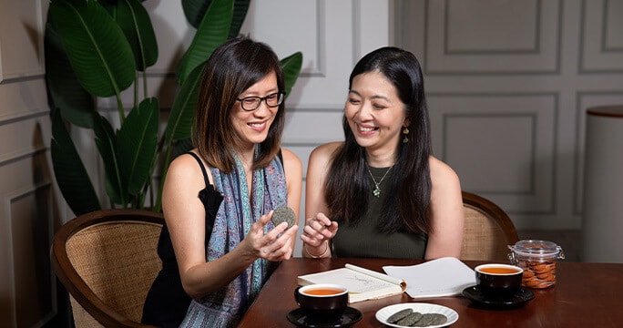 Lyn and Samantha peruse over business plans together in Sinpopo Brand.